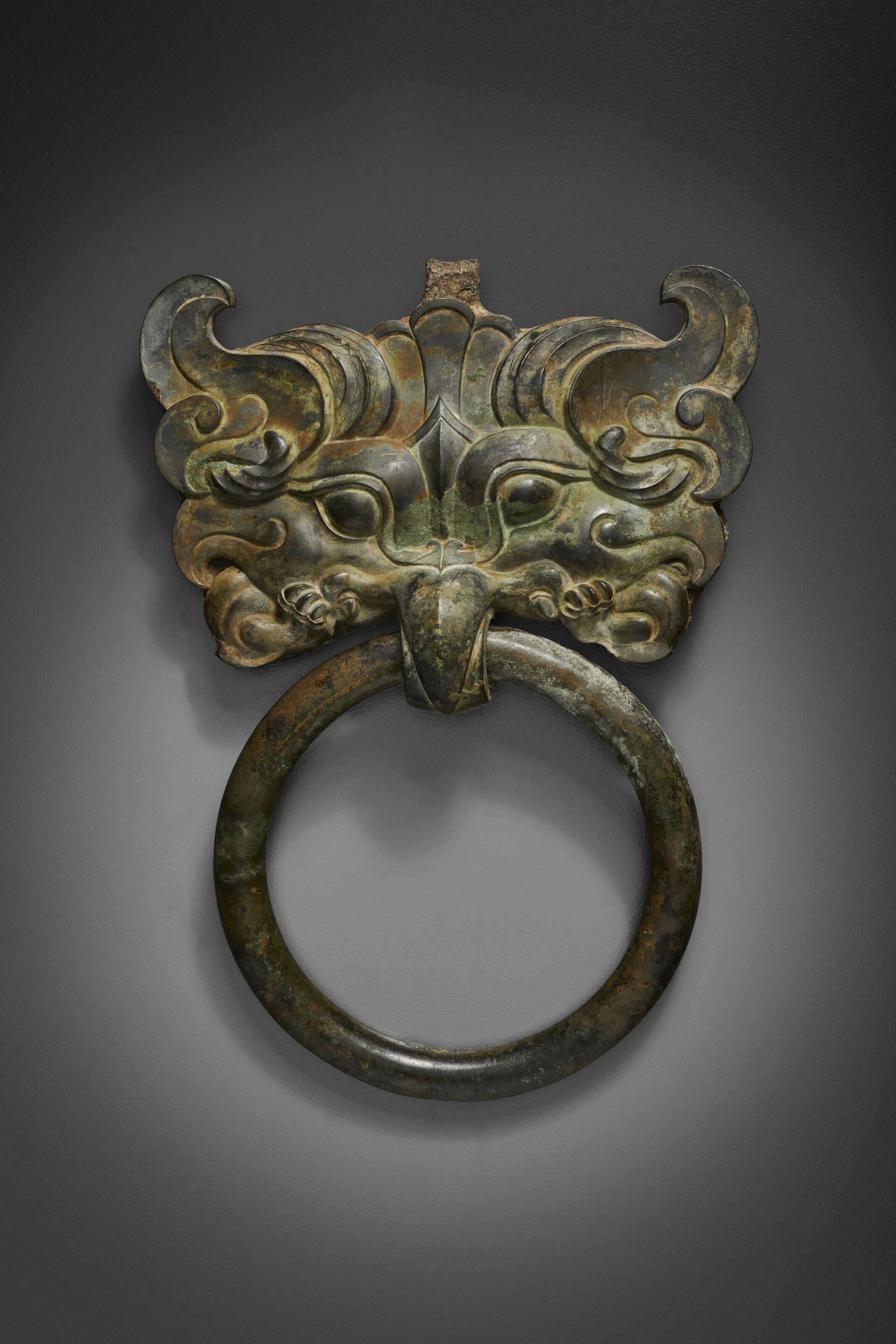 A BRONZE TAOTIE MASK FITTING WITH RING HANDLE