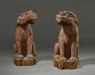 A PAIR OF WOOD SCULPTURES OF LIONS