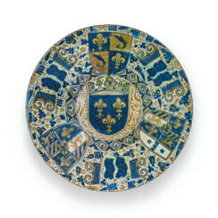 AN HISPANO-MORESQUE EARTHENWARE BLUE AND LUSTRED ARMORIAL CHARGER