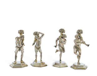 A SET OF FOUR CONTINENTAL PARCEL-GILT SILVER FIGURAL CANDLESTICKS