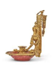 A LOUIS XVI ORMOLU AND RED LACQUER CHAMBERSTICK