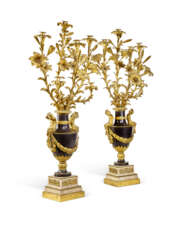 A PAIR OF FRENCH ORMOLU AND PATINATED BRONZE SIX-LIGHT CANDELABRA