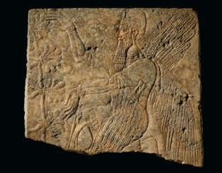 AN ASSYRIAN GYPSUM RELIEF OF A WINGED GENIUS
