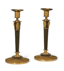 A PAIR OF CONSULAT ORMOLU AND PATINATED BRONZE CANDLESTICKS