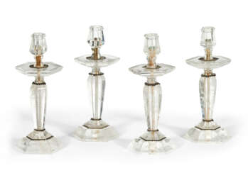 A SET OF FOUR SILVERED-METAL MOUNTED ROCK CRYSTAL CANDLESTICKS