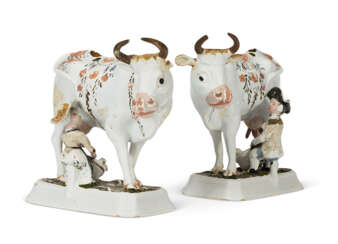 A PAIR OF DUTCH DELFT COLD-PAINTED MILKING GROUPS