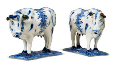 A PAIR OF DUTCH DELFT BLUE AND WHITE MODELS OF STANDING COWS