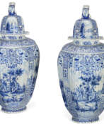Faience. A PAIR OF DUTCH DELFT BLUE AND WHITE VASES AND COVERS