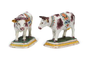 A PAIR OF DUTCH DELFT POLYCHROME MODELS OF COWS