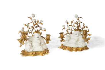 A PAIR OF FRENCH ORMOLU-MOUNTED AND PORCELAIN TWIN-LIGHT CANDELABRA