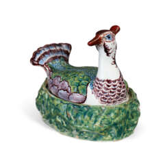 A DUTCH DELFT POLYCHROME BIRD-FORM BUTTER DISH AND A COVER