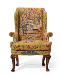 A GEORGE I WALNUT AND NEEDLEWORK WING ARMCHAIR