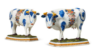 A PAIR OF DUTCH DELFT POLYCHROME MODELS OF STANDING COWS