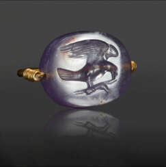 A GREEK GOLD AND PURPLE CHALCEDONY SCARABOID SWIVEL RING WITH AN EAGLE DEVOURING A HARE