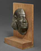 Granite. A FRAGMENTARY EGYPTIAN GRANITE PORTRAIT HEAD OF A MAN