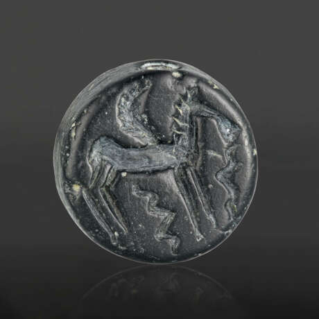 A GREEK BLACK SERPENTINE DOUBLE-SIDED DISK WITH A CENTAUR AND A WINGED HORSE - фото 1
