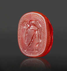AN ETRUSCAN CARNELIAN SCARAB WITH A YOUTH WITH A STRIGIL