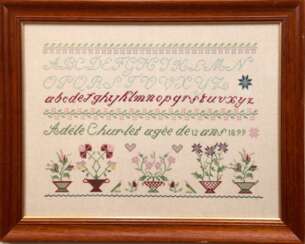 Stickmustertuch von Adle ´le Churlet, dat. 1899, ABC und florale Motive im Kreuzstich, ca. 42x56 cm, hinter Glas im Rahmen