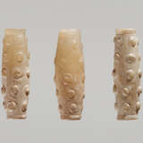 THREE TINY BI-CONICAL BEADS IN WHITE JADE WITH DELICATELY CARVED SCROLLS IN RELIEF - photo 1