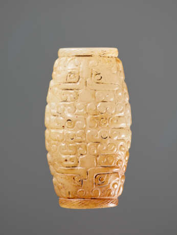 A SUPERB BARREL-SHAPED BEAD IN WHITE JADE WITH MASK MOTIFS AND CURLS IN RELIEF - photo 1