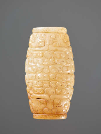 A SUPERB BARREL-SHAPED BEAD IN WHITE JADE WITH MASK MOTIFS AND CURLS IN RELIEF - photo 2
