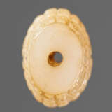 A SUPERB BARREL-SHAPED BEAD IN WHITE JADE WITH MASK MOTIFS AND CURLS IN RELIEF - photo 3