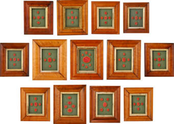 A GROUP OF THIRTEEN FRAMED SETS OF INTAGLIO SEALS AND MOLDS