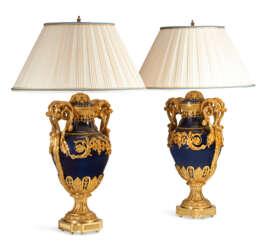 A PAIR OF FRENCH ORMOLU AND BLUED METAL VASES, NOW MOUNTED AS LAMPS