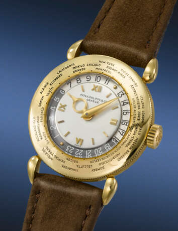 PATEK PHILIPPE. A VERY RARE AND ATTRACTIVE 18K GOLD WORLD TIME WRISTWATCH - photo 2