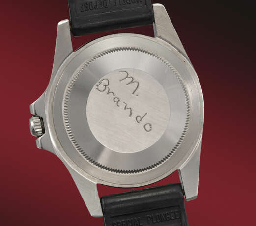 ROLEX. A FAMED AND HISTORICALLY IMPORTANT STAINLESS STEEL AUTOMATIC DUAL-TIME WRISTWATCH WITH DATE, THE CASEBACK HAND-ENGRAVED ‘M. BRANDO’ BY MARLON BRANDO HIMSELF - photo 3
