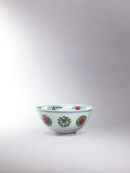 A RARE AND FINELY PAINTED DOUCAI ‘FRUIT AND FLOWER’ BOWL