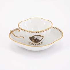 PORCELAIN CUP AND SAUCER WITH LANDSCAPE CARTOUCHES AND BASKET WEAVE RELIEF