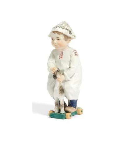 PORCELAIN FIGURINE OF A SMALL BOY WITH WOODEN HORSE - photo 1