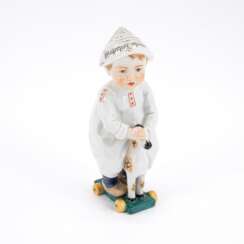 SMALL PORCELAIN BOY WITH NEWSPAPER HAT ON A LITTLE WOODEN HORSE