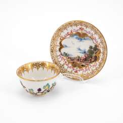 PORCELAIN TEA BOWL AND SAUCER WITH LANDSCAPE CARTOUCHES AND APPLIED VINE LEAVES DECOR