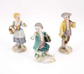 THREE FIGURINES OF CHILDREN COLLECTING FLOWERS ON ROCAILLE BASES