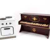 TOY PIANO MADE OF WOOD, BRASS AND PLASTIC AND A DOLL'S COOKING STOVE MADE OF SHEET METAL WITH ENAMEL DECOR - photo 1