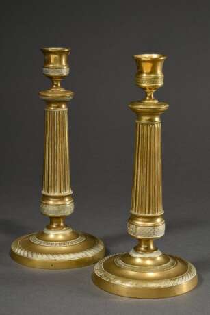 Paar feuervergoldete Bronze Leuchter auf rundem Fuß mit kannelierten Schäften und ornamentalen Friesen, Frankreich 19.Jh., H. 24,5cm, Druckstellen - photo 1