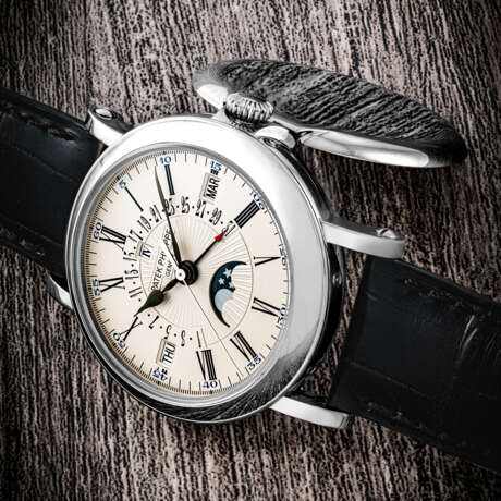 PATEK PHILIPPE. AN 18K WHITE GOLD AUTOMATIC PERPETUAL CALENDAR WRISTWATCH WITH SWEEP CENTRE SECONDS, RETROGRADE DATE, LEAP YEAR INDICATION AND MOON PHASES - фото 1