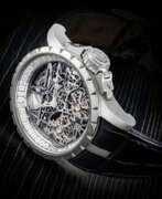 Диаманты. ROGER DUBUIS. A RARE 18K WHITE GOLD AND DIAMOND-SET LIMITED EDITION SKELETONISED DOUBLE TOURBILLION WRISTWATCH