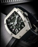 Richard Mille. RICHARD MILLE. AN 18K WHITE GOLD AUTOMATIC SEMI-SKELETONISED WRISTWATCH WITH SWEEP CENTRE SECONDS AND DATE