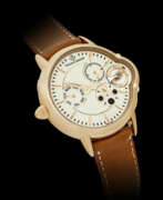Power reserve indicator. VINCENT BERARD. AN 18K PINK GOLD LEFT HANDED WRISTWATCH WITH DAY, MOON PHASES AND POWER RESERVE