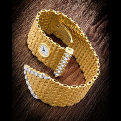 CARTIER. A LADY’S VINTAGE AND UNUSUAL 18K GOLD AND DIAMOND-SET BRACELET WATCH WITH “SECRET” DIAL