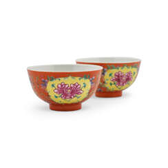 TWO ENAMELLED CORAL-GROUND FAMILLE ROSE ‘PEONY’ BOWLS