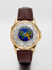 PATEK PHILIPPE. A RARE AND ATTRACTIVE 18K GOLD AUTOMATIC WORLD TIME WRISTWATCH WITH CLOISONNE ENAMEL DIAL
