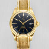 OMEGA. AN IMPRESSIVE AND HEAVY 18K GOLD AUTOMATIC DUAL-TIME WRISTWATCH WITH SWEEP CENTRE SECONDS, DATE AND BRACELET - photo 1