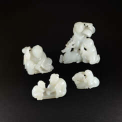 A GROUP OF FOUR WHITE JADE ‘FIGURAL’ CARVINGS