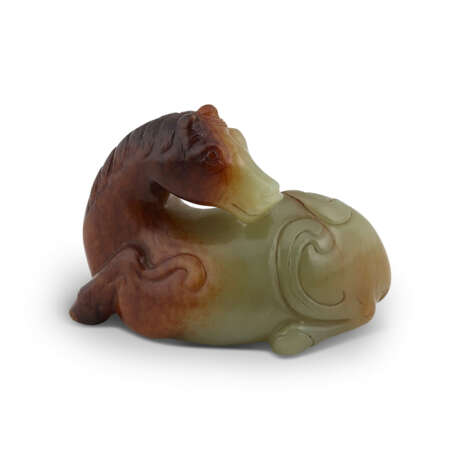 A CELADON AND RUSSET JADE CARVING OF A RECUMBENT HORSE - photo 2