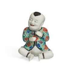 A CHINESE EXPORT PORCELAIN FIGURE OF A SEATED BOY