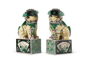 A PAIR OF CHINESE EXPORT PORCELAIN BUDDHISTIC LIONS ON STANDS